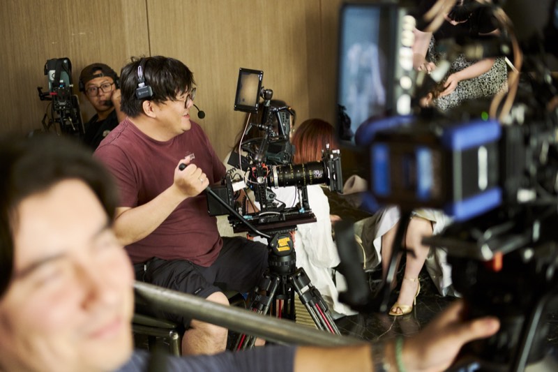 Behind-the-scenes view of a lit interior set during filming.