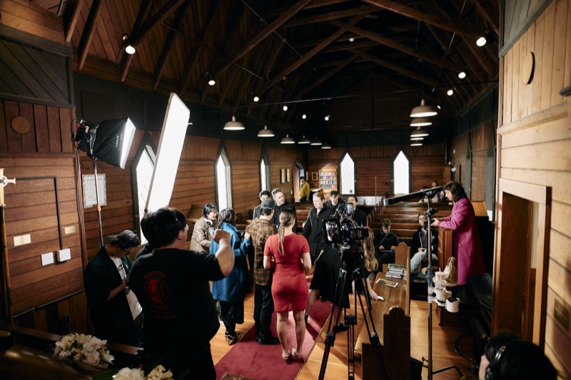 Camera operator and crew filming a scene on location in Vancouver.
