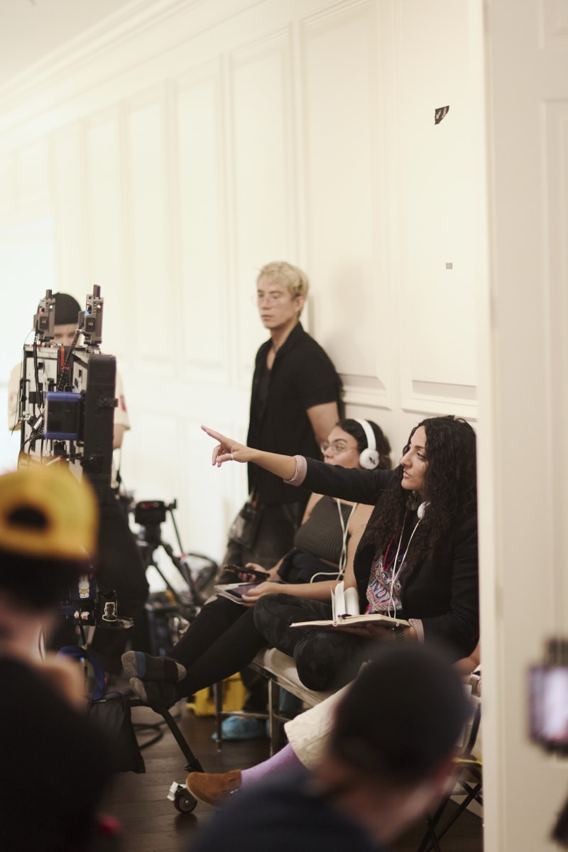 Behind-the-scenes view of a lit interior set during filming.